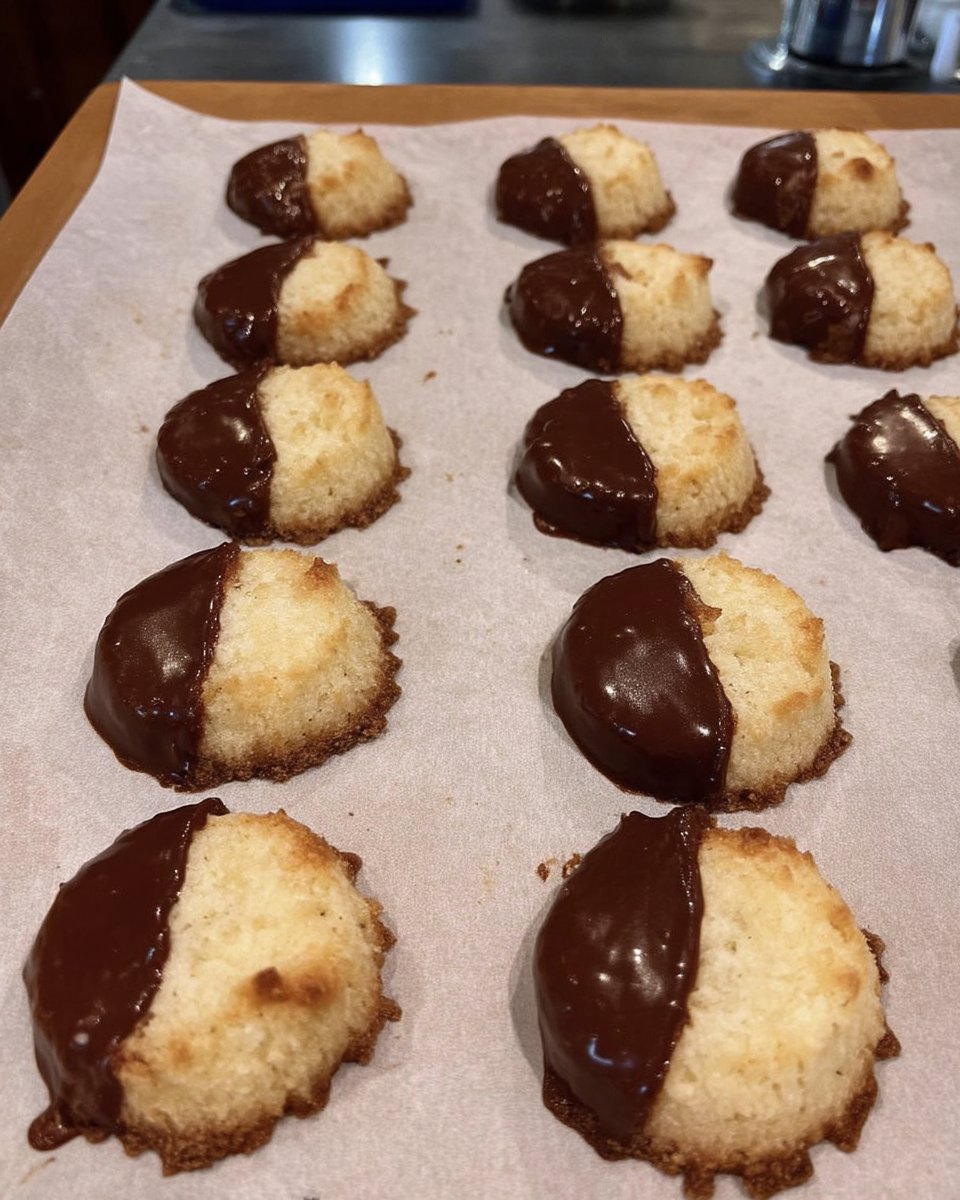 Classic dipped shortbread cookies with chocolate and sea salt on a rack