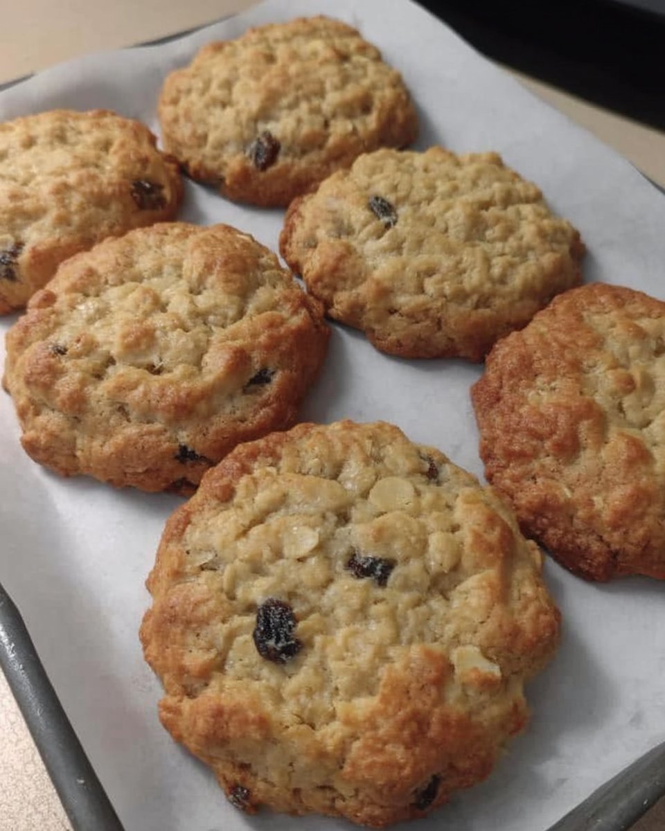 Soft and chewy oatmeal raisin cookies stacked on a cooling rack