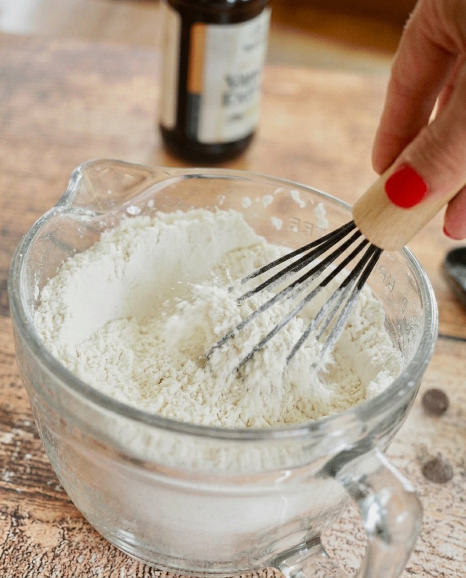 Dried cherries, chocolate chips, and cherry preserves on a marble counter