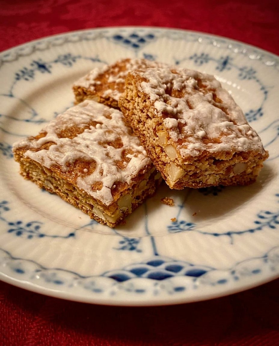 A tray of rectangular Basler Lackerli cookies with a thin white glaze