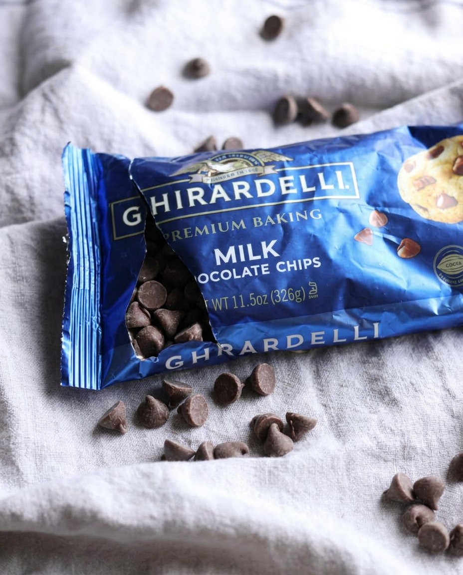 Freshly baked cookies cooling on a wire rack with melting chocolate