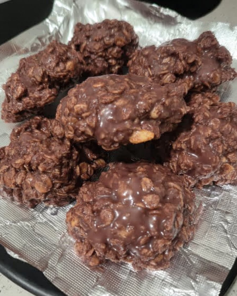 A plate of no bake chocolate oatmeal cookies next to a glass of cold milk