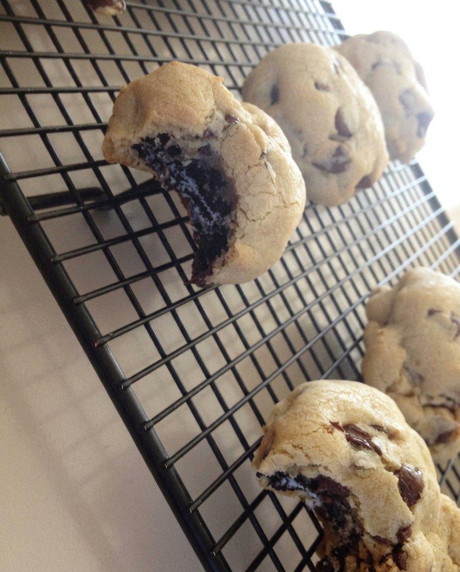 Oreo stuffed chocolate chip cookie served with a glass of cold milk