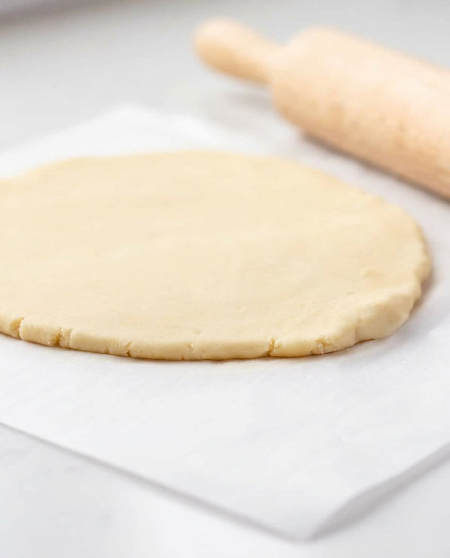 Scooping chilled soft batch cookie dough onto a baking sheet.