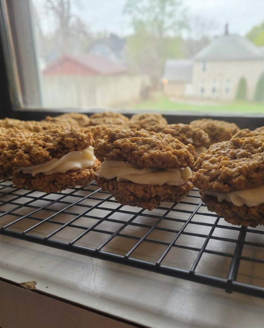 A stack of oatmeal cream pies next to a glass of milk