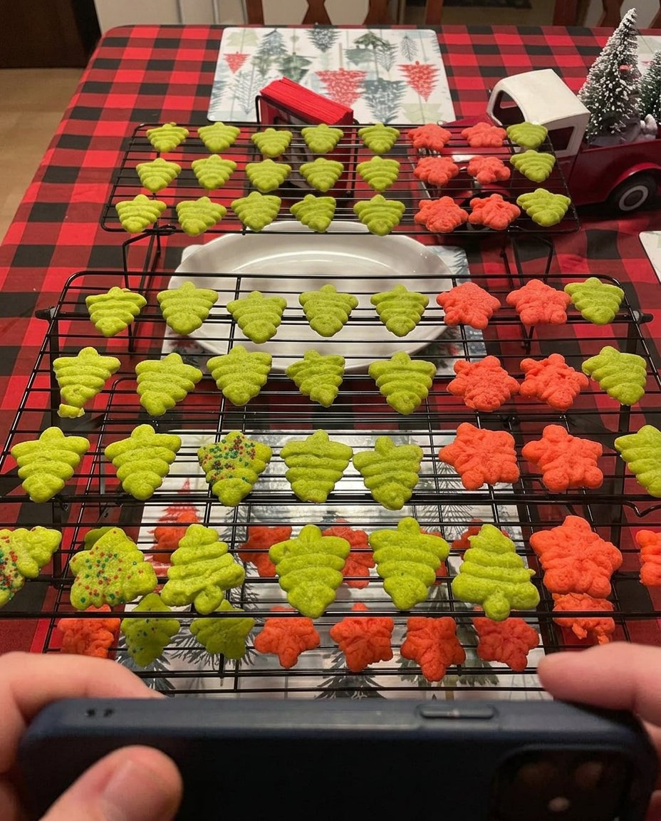 Festive butter spritz cookies arranged on a wire cooling rack