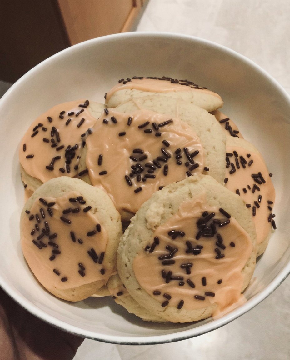 Decorated vegan sugar cookies with white icing and sprinkles